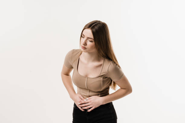 Sick attractive girl hold abdomen because it hurts. Stomach pain. Pancreatitis disease of pancreas becomes inflamed. Sick attractive girl hold abdomen because it hurts. Stomach pain. Pancreatitis disease of pancreas becomes inflamed endometriosis bloated stock pictures, royalty-free photos & images