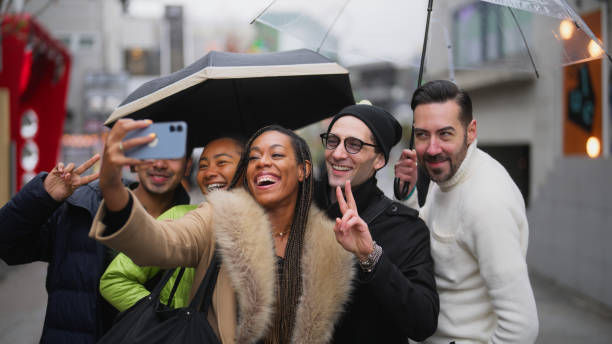 multi-racial group of tourist friends taking selfies and videos while exploring the city in harajuku tokyo - japanese culture japan japanese ethnicity asian and indian ethnicities imagens e fotografias de stock