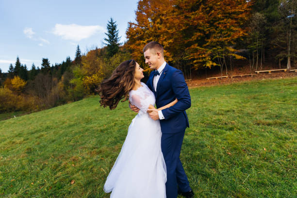 istock The bride and groom are dancing in nature looking at each other 1470325549