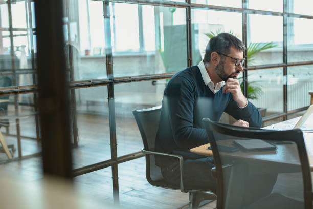 istock Successful businessman in glasses typing laptop at workplace 1470325630