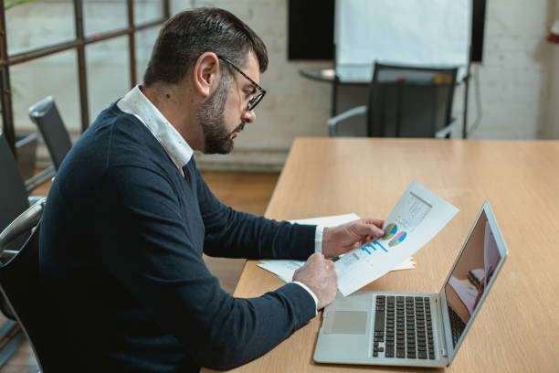 istock Thoughtful adult bearded male analyzing business information 1470326725