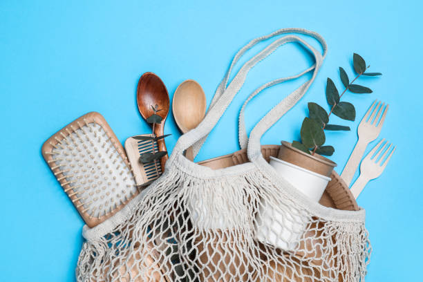 istock Net bag with different eco items on light blue background, top view. Recycling concept 1470327070