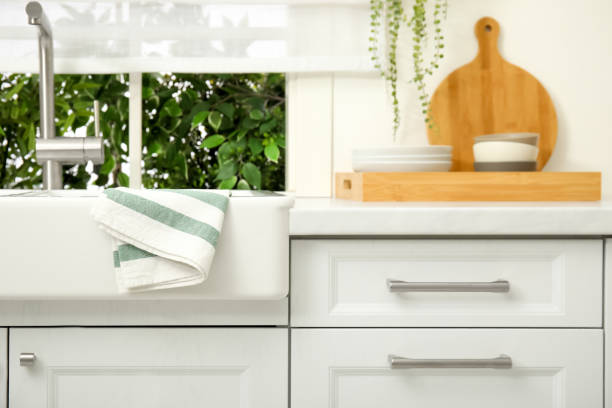 istock Clean towel hanging on white sink in kitchen 1470327180