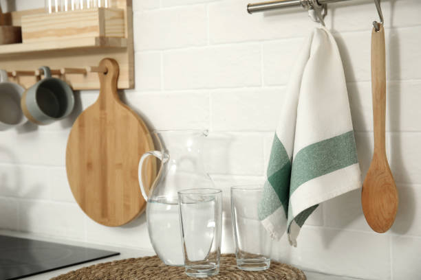 istock Jug with water, glasses, towel and utensils in kitchen 1470327198