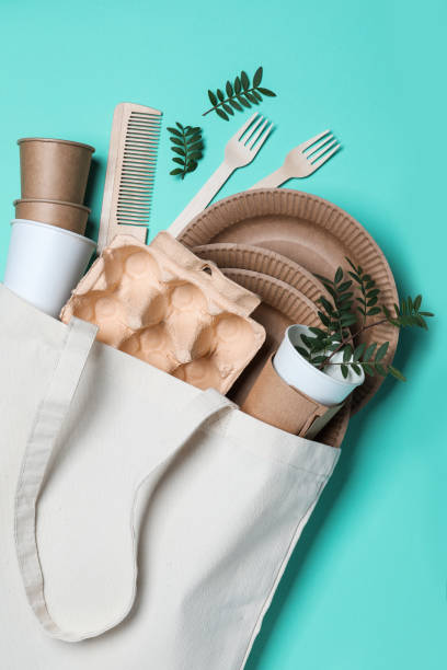 istock Eco bag with different disposable items on turquoise background, flat lay. Recycling concept 1470327272