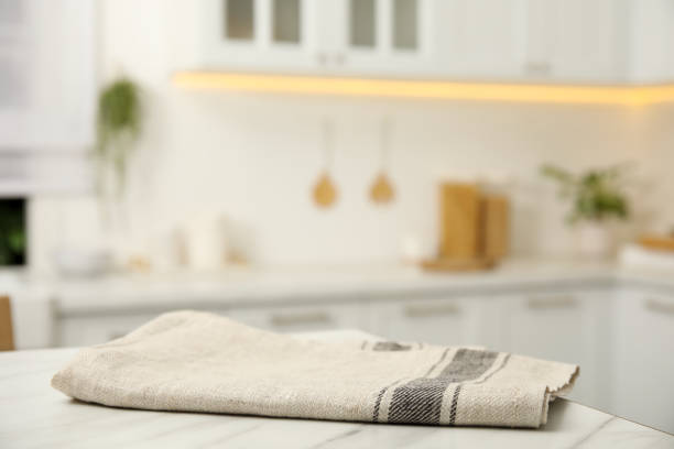 istock Clean towel on white marble table in kitchen 1470327300