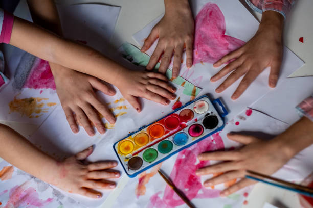 istock High angle view children hands at the table painting 1470330306