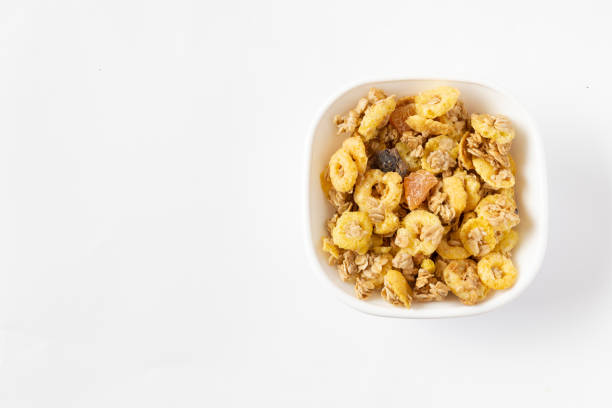 Granola in a white bowl on white background