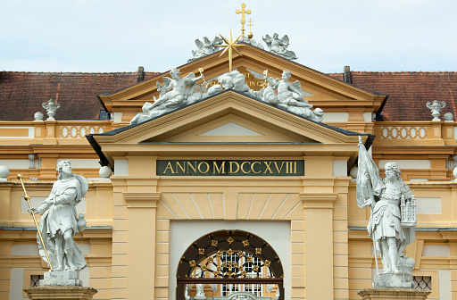 The view of a baroque style Melk Abbey entrance with sculptures and a sign year 1718 showing when it was built (Melk, Austria).