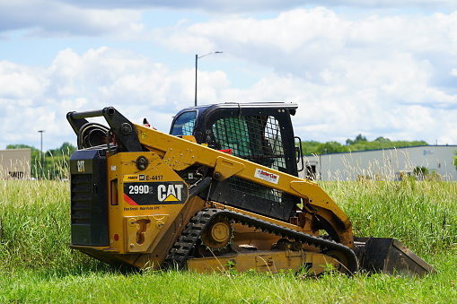 Mauston, Wisconsin USA - July 25th, 2022: Caterpillar 299D2 sits on roadside ready to be used.