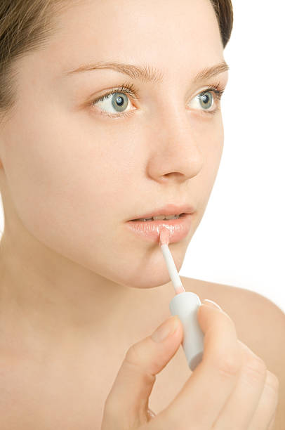 istock Beautiful young woman painting her lips 147033782