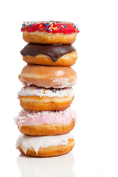 Stack of decorated donuts on white background stock photo