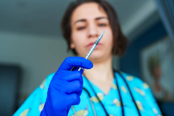 Close-up nurse holds syringe for medication