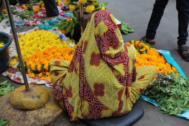 A woman sells marigolds at a market in Mumbai