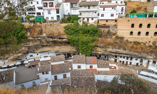 Exposure of Setenil de las Bodegas famous for its dwellings built into rock overhangs above the Río Guadalporcún, Cadiz, Spain