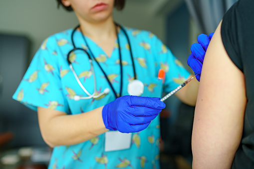 Close-up nurse holds syringe for medication