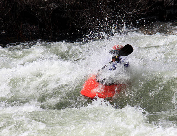 Red kayak whitewater rapids stock photo