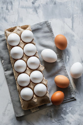 Fresh organic chicken eggs on a gray rustic background