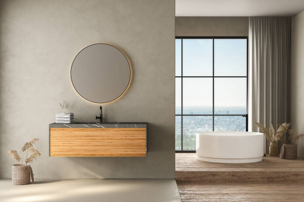 istock Modern bathroom interior with gray wall and travertine floor, white oval bathtub, marble basin, front view. Minimalist bathroom with modern furniture and city view. 3D rendering 1470349267