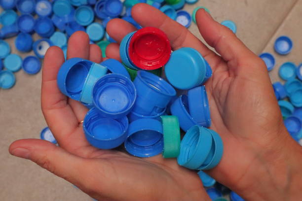 istock Person Holding Blue Bottle Caps in their Hands 1470352223