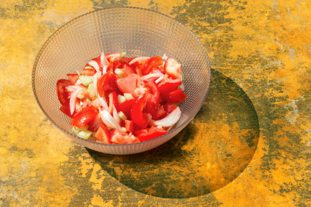 Healthy tomato salad . Chopped tomatoes and onions in the plate