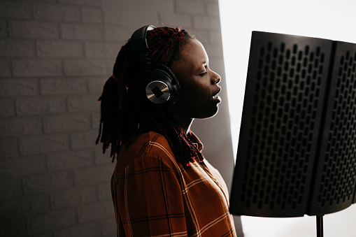 Young Woman Recording in a music studio