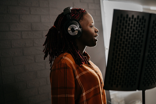 Young Woman Recording in a music studio