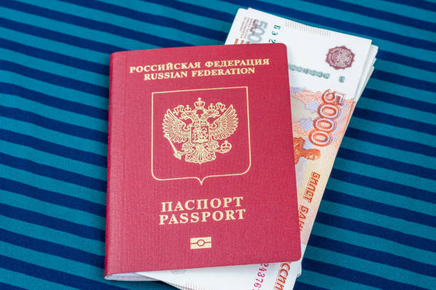 istock Documents and money. 5000 rubles in Russian passport on blue textile background 1470354745