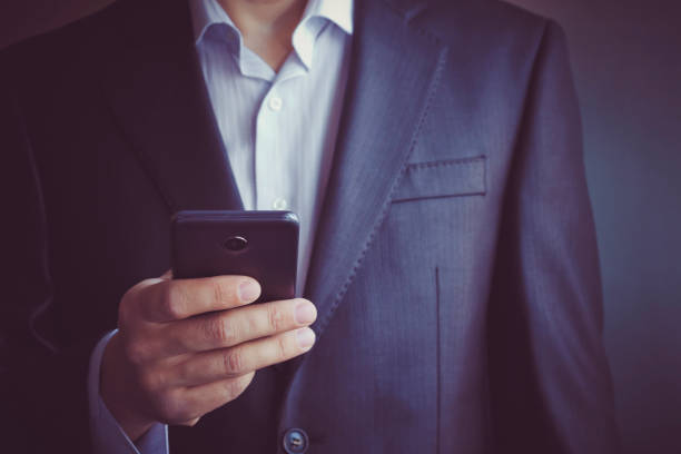 istock Business process. Bussinessman, manager using mobile phone. Typing contemporary smartphone screen. 1470354770