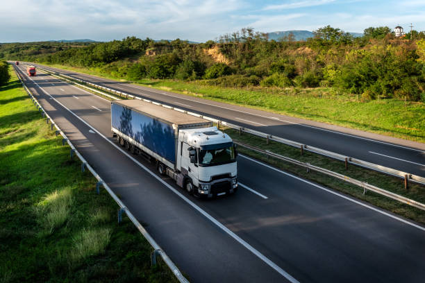 istock White truck driving on the highway 1470354796