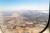 Wing view of plane departing airport and flying over Cairo city, Egypt