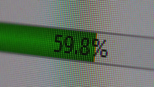 extremely close-up of the scale of downloading and transferring files on the screen of a computer monitor. uploading files to the server.selective focus