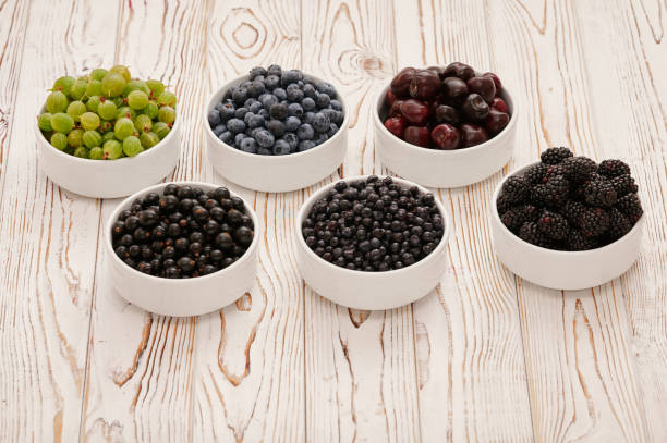 istock Fresh berries in six bowls on a wooden background. Fruit berry background. 1470357849