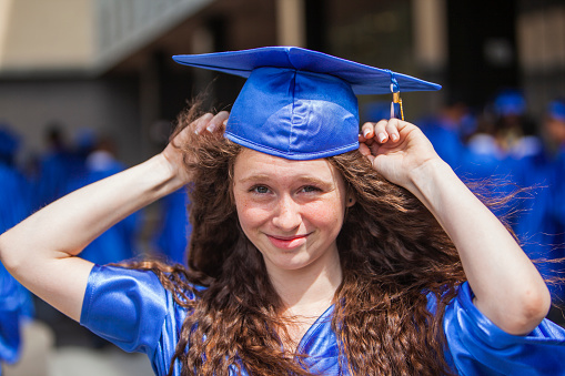 Middle-school student, a teenage girl, getting graduated.