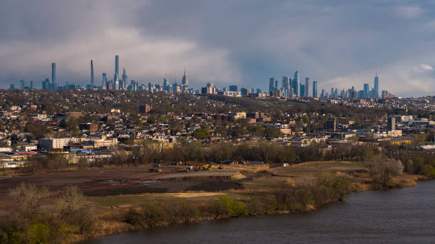 istock Massive construction at the river shore destroyed the park, creating environmental issues and ecological problems. Overpeck Creek River in Overpeck County Park, Leonia, New Jersey, with distant view of Manhattan and Jersey City. 1470358260