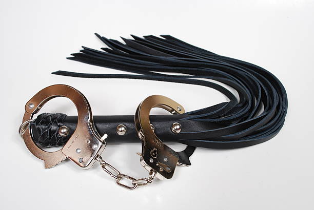 Leather Whip and Handcuffs stock photo