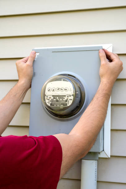 istock Electric power meter box for home use. Man looking on electricity meter at home. Power outage, blackout concept. 1470363270