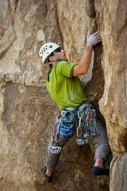 istock Rock climber clinging to a cliff. 147036760