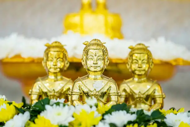 Photo of Portrait of three Golden boy Kumanthong top altar with flower. Kumanthong is be soul of a boy and superstition about spiritual in Thailand.