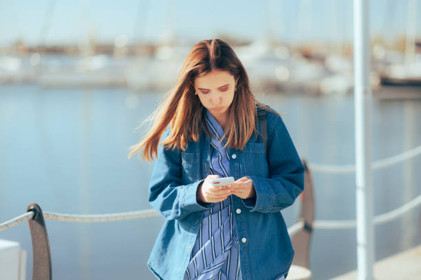 istock Stressed Tourist Feeling Lost Checking her Phone for Directions 1470371322