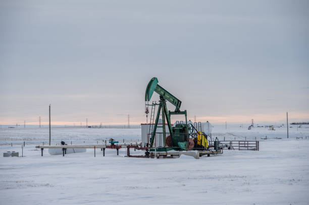 istock Oil pump jack in winter 1470371883
