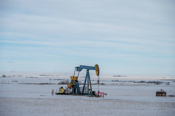istock Oil pump jack in winter 1470371884