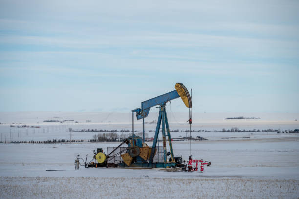 istock Oil pump jack in winter 1470371885
