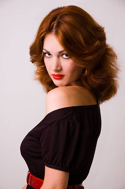 The red-haired girl with red lips stock photo