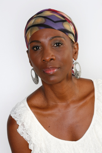 pretty woman in colorful head scarf on a white backdrop