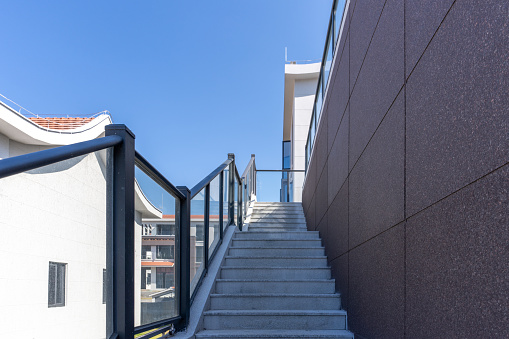 A metal railing alongside a building access ramp