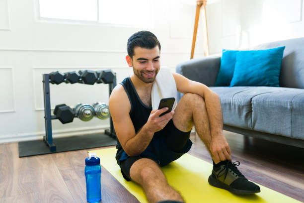 istock Happy fit man texting using his smartphone after exercising 1470376962