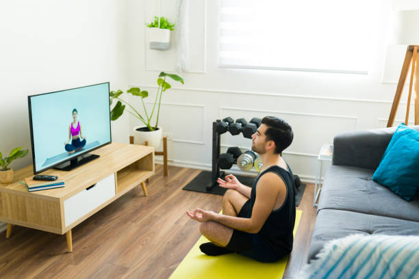 istock Relaxed latin man watching a meditation video at home 1470376980