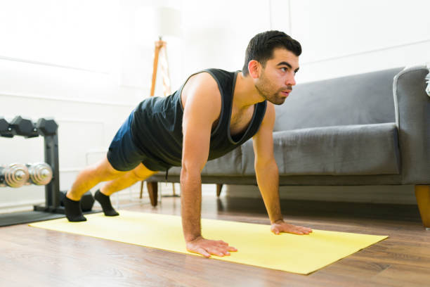 istock Attractive active man doing plank exercises at home 1470377053