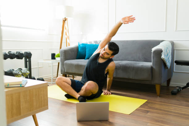 istock Sporty man warming up and stretching before exercising 1470377069